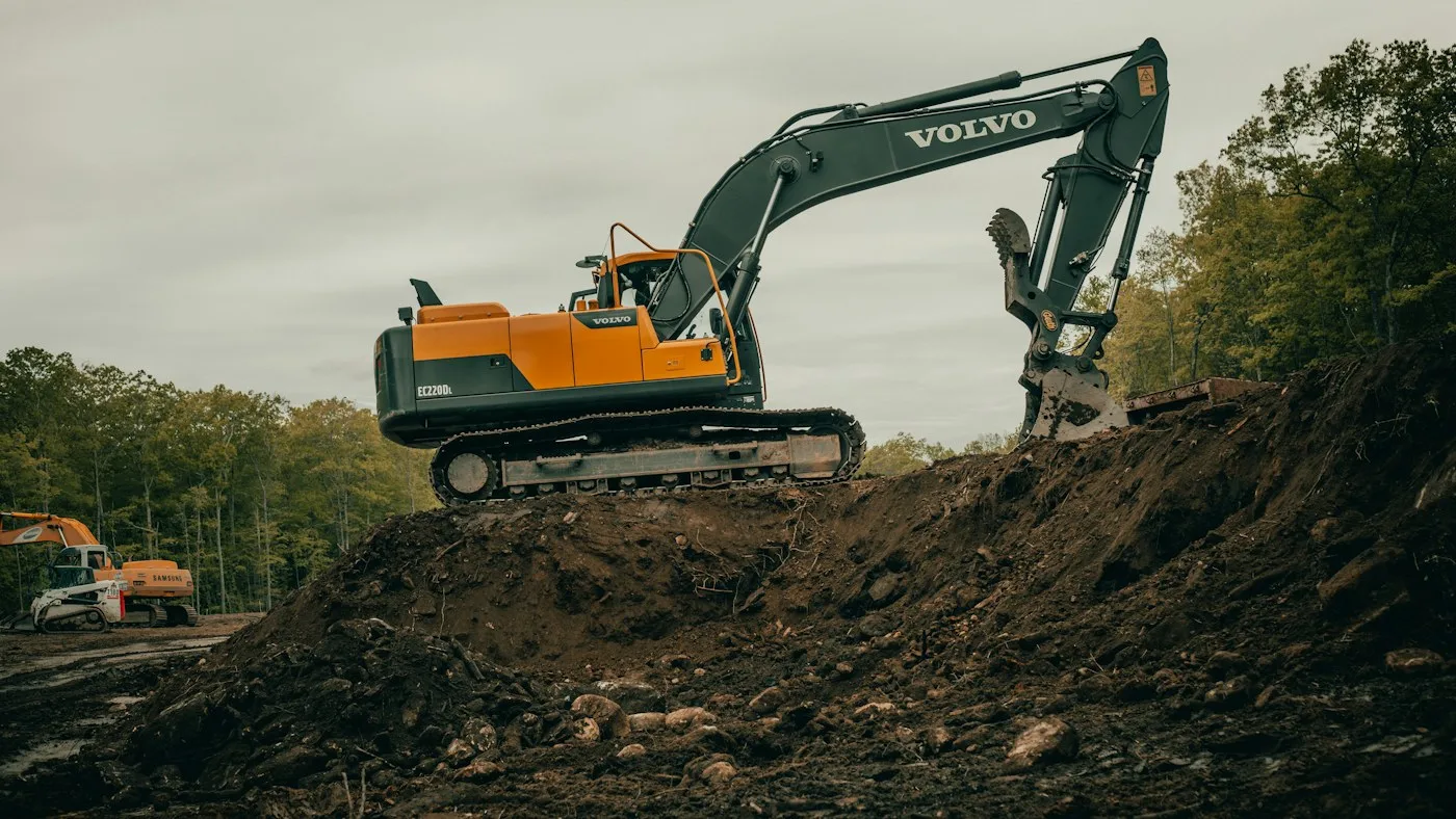 Tracked excavator on dark exposed ground