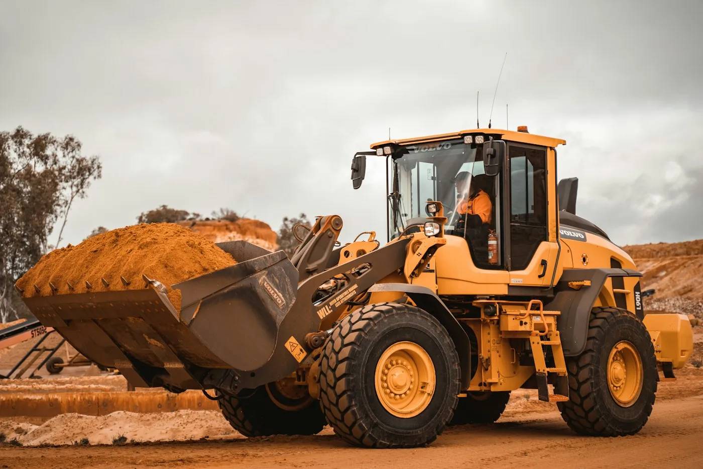 Wheel loader carrying a load of earth